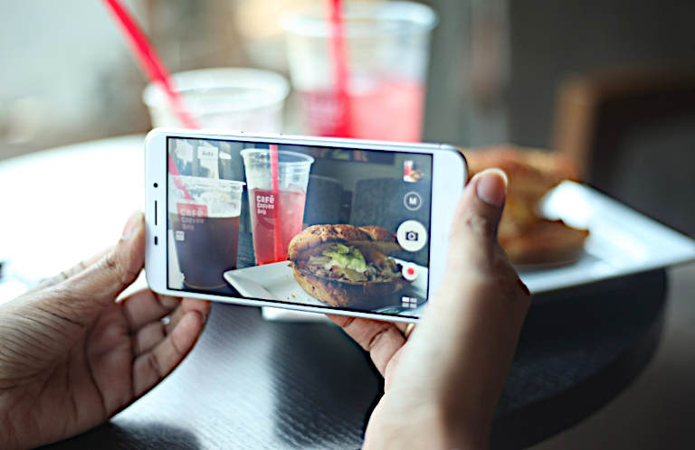 Food Porn - Il Push-up del cibo digitale smartphone in primo piano con piatto